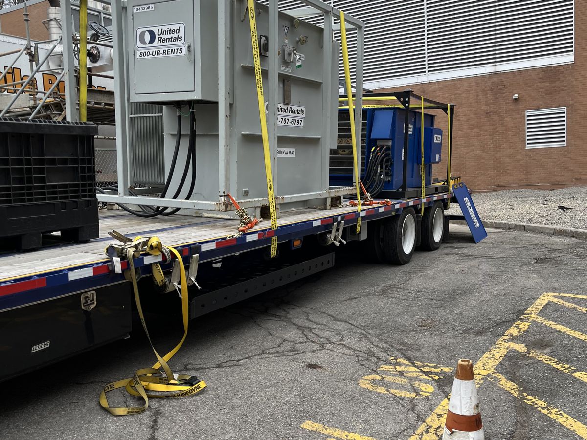 A commercial load bank connected with heavy test cables during an on-site generator load test by 2G Power Solutions