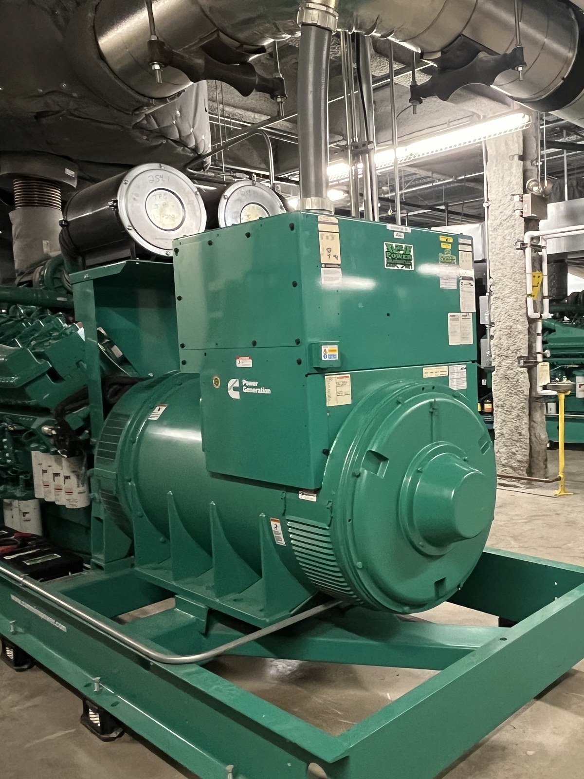 A large commercial standby generator in a facility power room, serviced by 2G Power Solutions across Western Pennsylvania