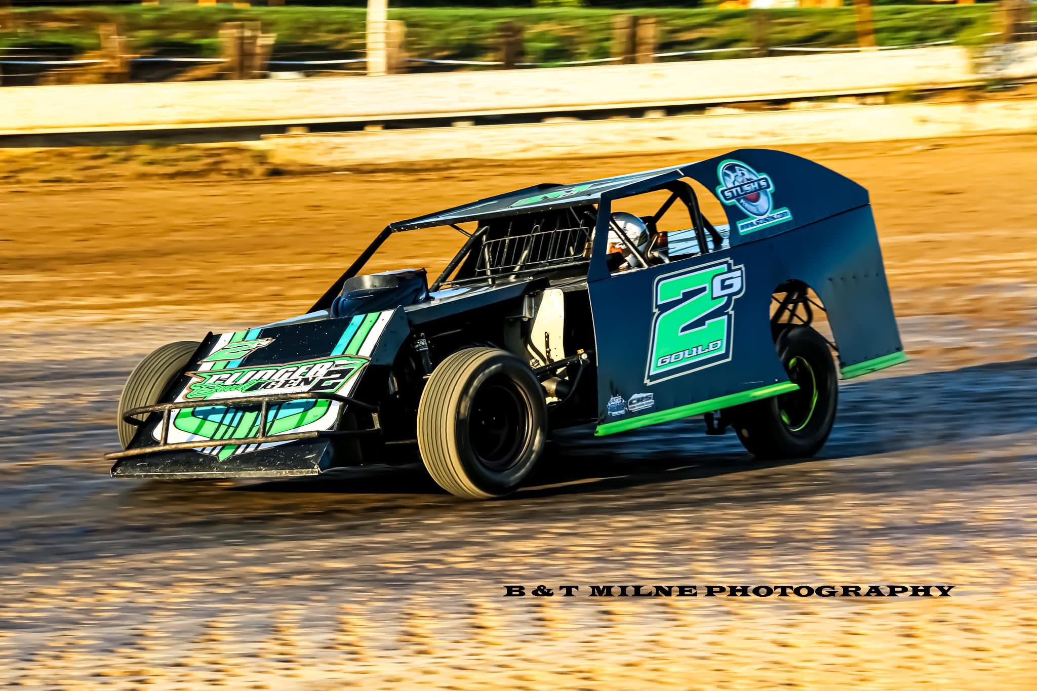 The No. 2G Gould dirt modified race car on a dirt oval — photo by B & T Milne Photography