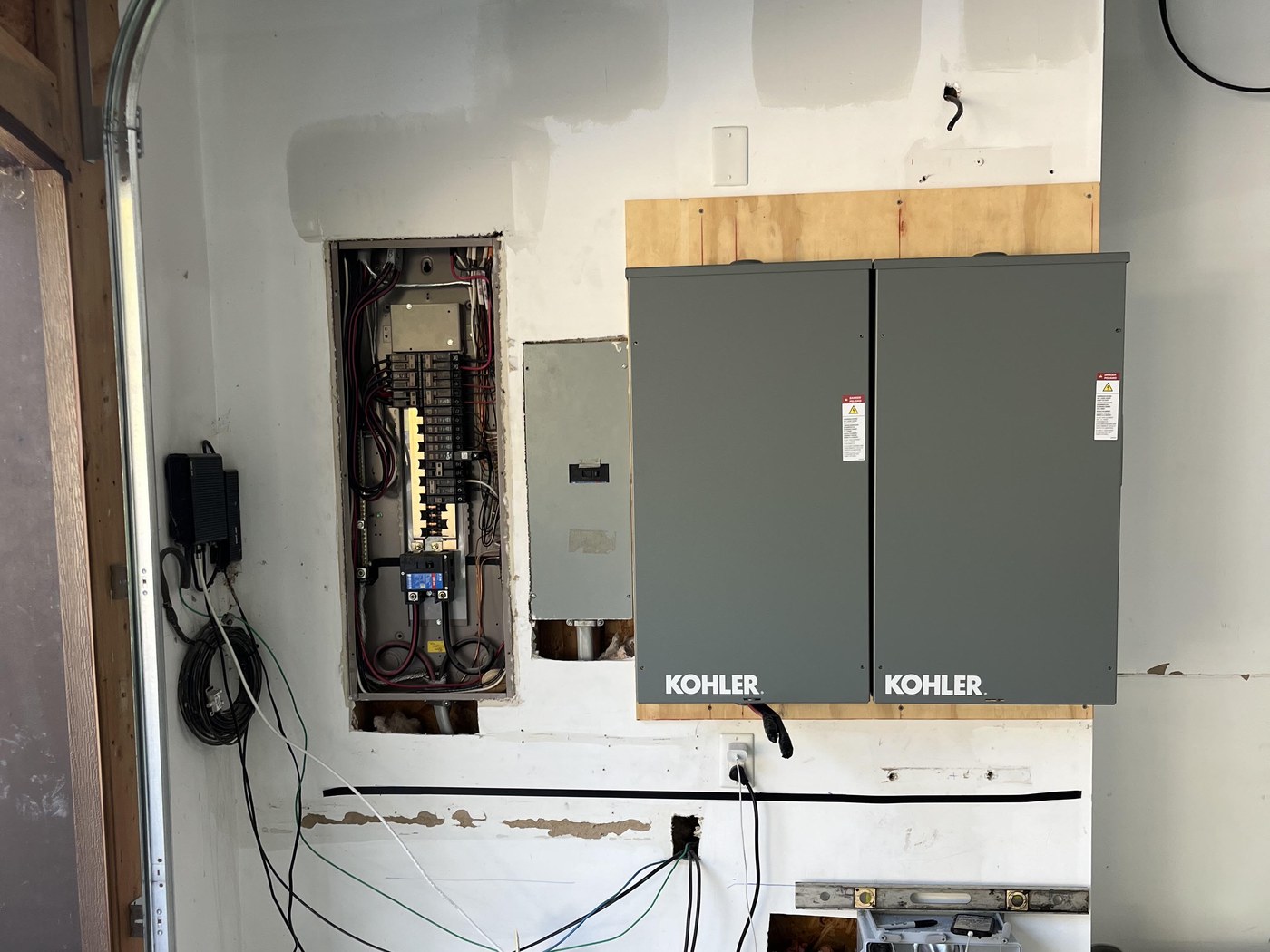 Kohler automatic transfer switches installed in a home garage by 2G Power Solutions