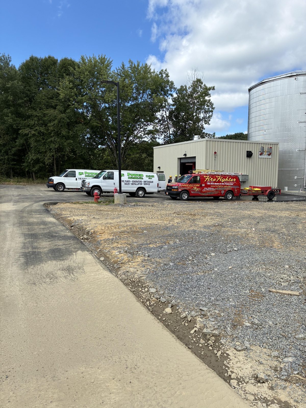 2G Power Solutions service vans and technicians on a job site in the New Castle and Lawrence County area